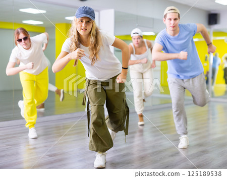 Teen girl in cap dancing modern dances Teen girl in cap dancing modern dances 125189538