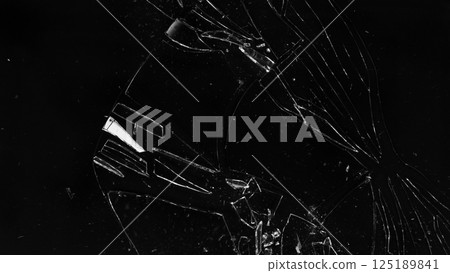 broken cracked glass with big hole over black background broken cracked glass with big hole over black background 125189841