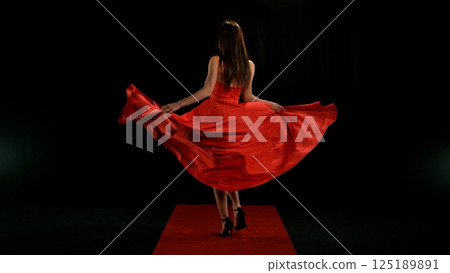 Woman in red dress dancing with flying fabric, Fashion Model Girl Posing with waving cloth Woman in red dress dancing with flying fabric, Fashion Model Girl Posing with waving cloth 125189891