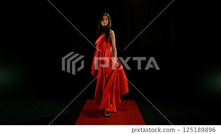 Woman in red dress dancing with flying fabric, Fashion Model Girl Posing with waving cloth Woman in red dress dancing with flying fabric, Fashion Model Girl Posing with waving cloth 125189896