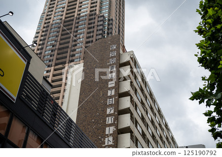 A skyscraper towering over a valley of buildings A skyscraper towering over a valley of buildings 125190792