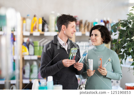 Husband and wife buy toothbrushes 125190853