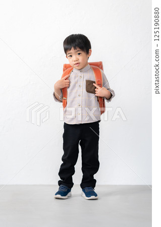 5-year-old boy carrying a school bag 5-year-old boy carrying a school bag 125190880