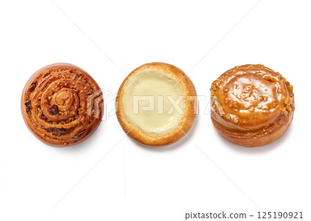 Raisin, cheesecake and peanut caramel bun isolated on white background 125190921