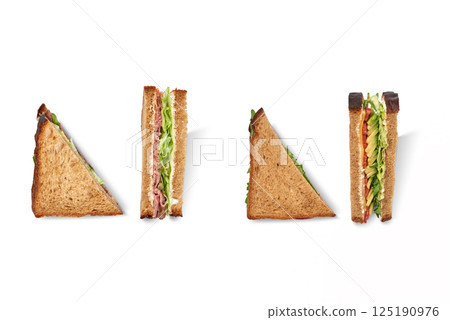 Cut club sandwich made with ham, avocado, cheese and iceberg lettuce isolated 125190976
