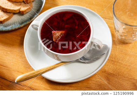 Borscht soup with beets served in bowl Borscht soup with beets served in bowl 125190996