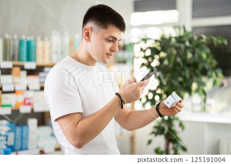 Guy scans barcode on ointment box 125191004