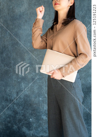 A young woman posing with a laptop A young woman posing with a laptop 125191223