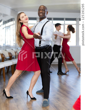 African man and woman dancing waltz in couple during lesson at studio African man and woman dancing waltz in couple during lesson at studio 125191295