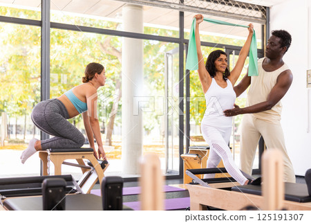 Aerobics pilates women with rubber bands closeup 125191307