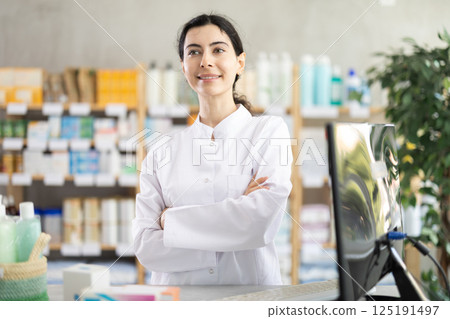 woman pharmacist stands in a pharmacy woman pharmacist stands in a pharmacy 125191497
