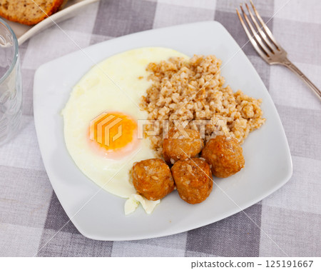 Meatballs with scrambled eggs and oatmeal - healthy lunch 125191667