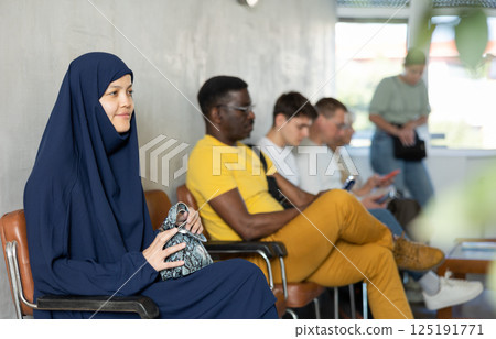 Young arab woman waiting in line at reception Young arab woman waiting in line at reception 125191771