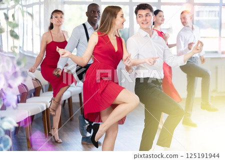 Young guy and young woman dance twist 125191944