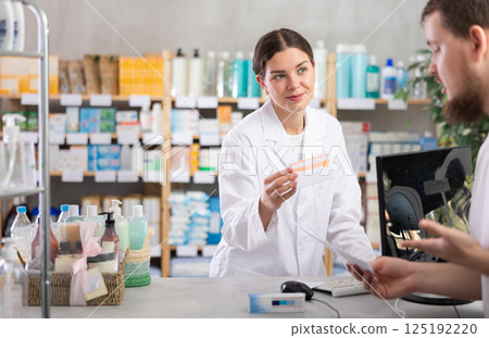 Female pharmacist offers to buy pills for man at pharmacy Female pharmacist offers to buy pills for man at pharmacy 125192220