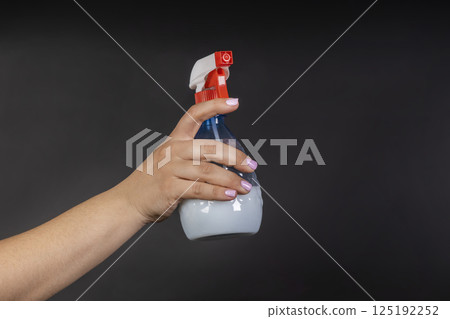 Water sprayer bottle in hand. household items for home Water sprayer bottle in hand. household items for home 125192252