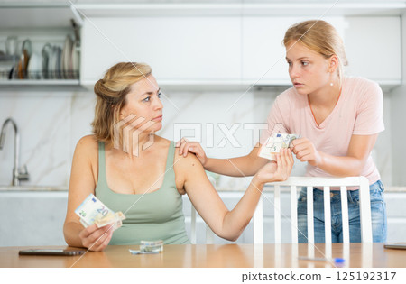 Woman received salary giving pocket money to teenage daughter Woman received salary giving pocket money to teenage daughter 125192317