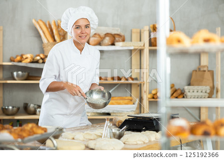 Girl mixes liquid ingredients in bowl with whisk 125192366