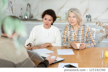Mother and daughter considering offer from agent 125192390