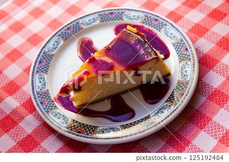 Slice of delicious cheesecake with berries jam Slice of delicious cheesecake with berries jam 125192484
