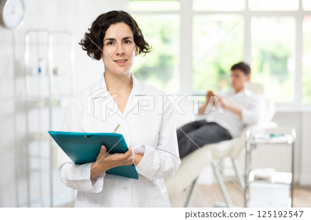 female doctor with folder female doctor with folder 125192547