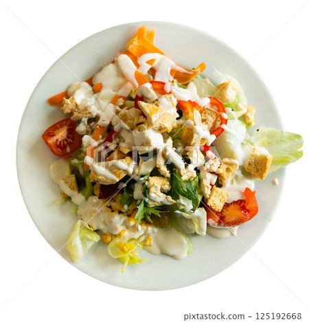 Caesar salad with chicken pieces, tomatoes on a white plate Caesar salad with chicken pieces, tomatoes on a white plate 125192668
