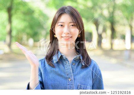 Young woman giving directions in the park Young woman giving directions in the park 125192816