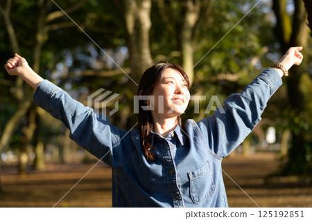 A young woman stretching in the sunlight A young woman stretching in the sunlight 125192851