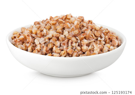 Boiled buckwheat in a ceramic bowl isolated on white background 125193174