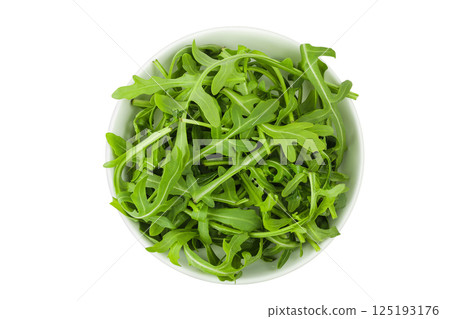 Heap of green fresh rucola or arugula leaf in ceramic bowl isolated on white background. Top view, flat lay 125193176
