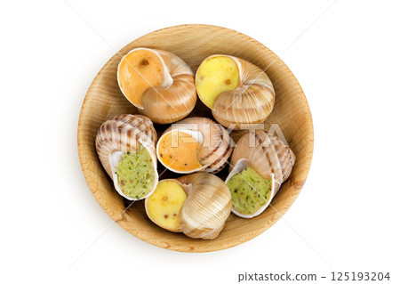 escargot snail filled with different fillings in wooden bowl isolated on white background. Top view. Flat lay escargot snail filled with different fillings in wooden bowl isolated on white background. Top view. Flat lay 125193204