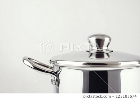 Stainless steel cooking pot with lid on white background 125193674