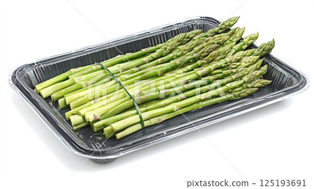 Fresh green asparagus packed in plastic tray on white background 125193691