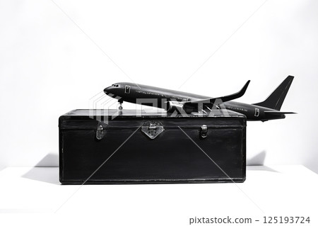 Toy airplane taking off from vintage suitcase symbolizing travel and adventure Toy airplane taking off from vintage suitcase symbolizing travel and adventure 125193724