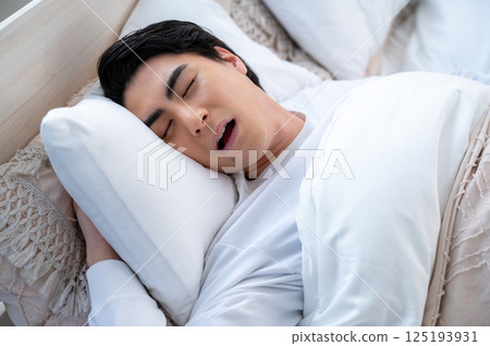 A young man sleeping and snoring 125193931