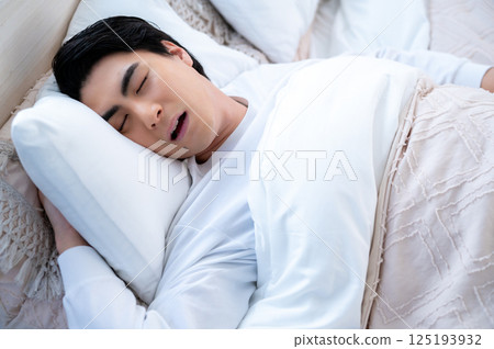 A young man sleeping and snoring A young man sleeping and snoring 125193932