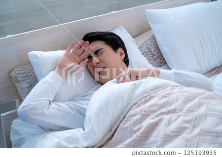 Unwell young man sleeping in bed 125193935