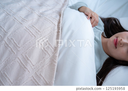 A young woman sleeping in bed A young woman sleeping in bed 125193958