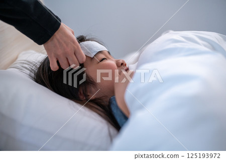 A girl being nursed for being unwell A girl being nursed for being unwell 125193972