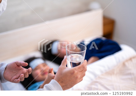 A man taking care of an unwell family member 125193992