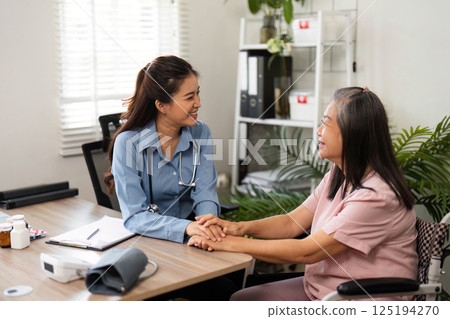 Positive Interactions in Healthcare. A nurse and elderly patient share smiles during a consultation in a warm environment. 125194270