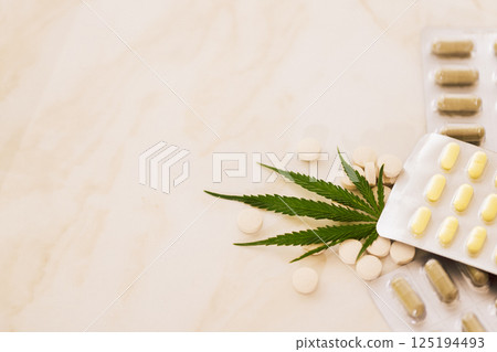 Mockups of medicines on a beige background with cannabis leaf. 125194493