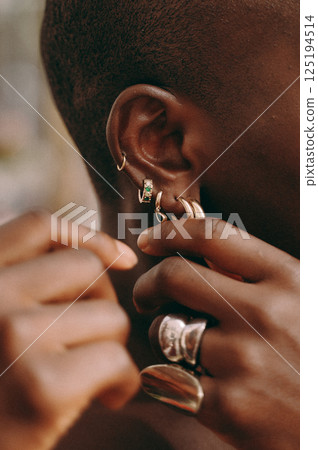 Close-Up of Stylish Earrings and Rings on Ear Close-Up of Stylish Earrings and Rings on Ear 125194514