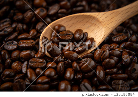 Coffee beans on a wooden spoon 125195094