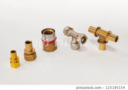 A variety of brass fittings on white foam. A variety of brass fittings on white foam. 125195154