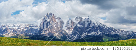 Majestic mountain range with snow-covered peaks under vibrant sky near Valley of Funes at Dolomites, Italy Majestic mountain range with snow-covered peaks under vibrant sky near Valley of Funes at Dolomites, Italy 125195192