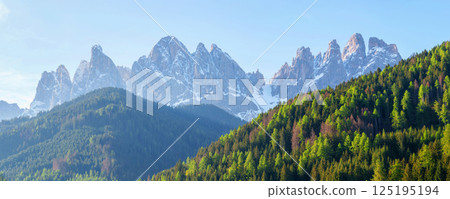 Majestic mountain range with forest in daylight near Valley of Funes at Dolomites, Italy Majestic mountain range with forest in daylight near Valley of Funes at Dolomites, Italy 125195194