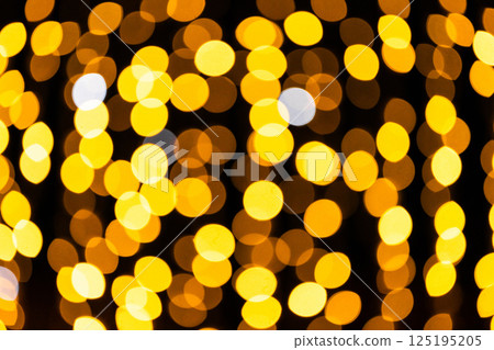 Golden bokeh lights on dark background Golden bokeh lights on dark background 125195205