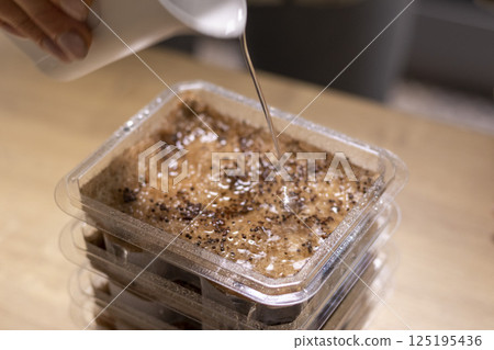 Person plants seeds of micro greens to the jute mat. 125195436