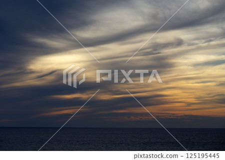 Colourful sunset over sea water. 125195445